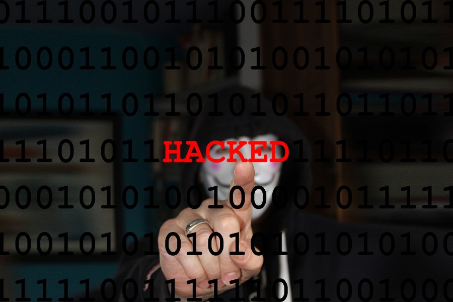 Photo of hacker in mask illustrated by our managed IT company in San Marcos TX