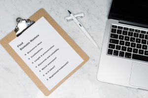 checklist on a clipboard for the different questions to ask when getting a new website domain
